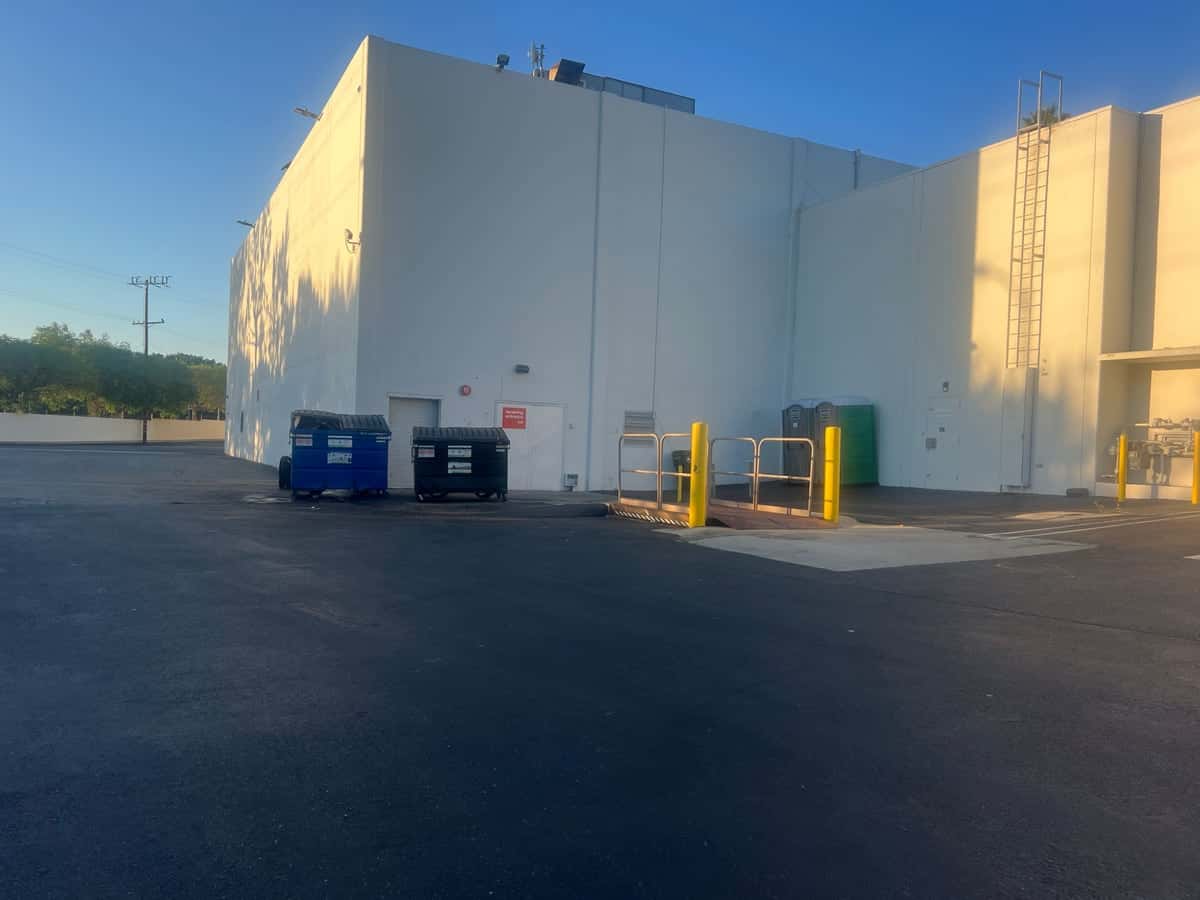 Clean loading dock and dumpster area behind a retail building after a Guardian service visit